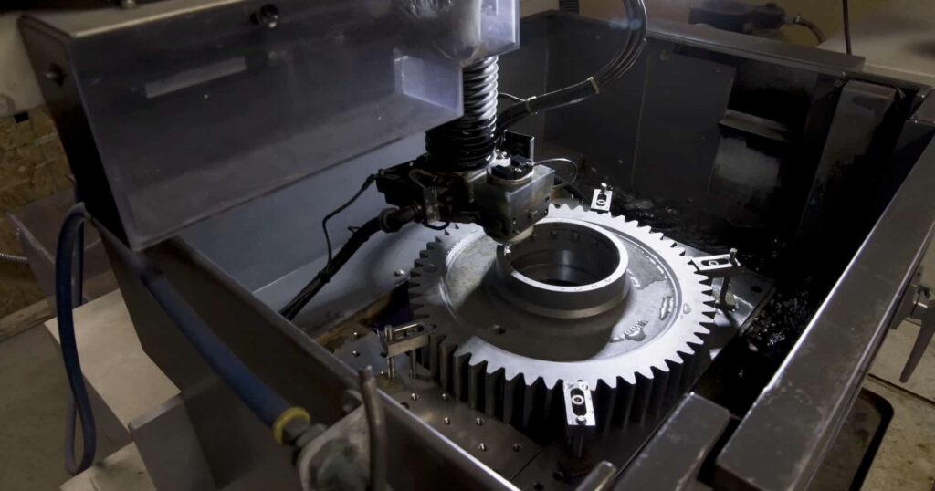 Wire EDM machining in progress on a precision metal gear component